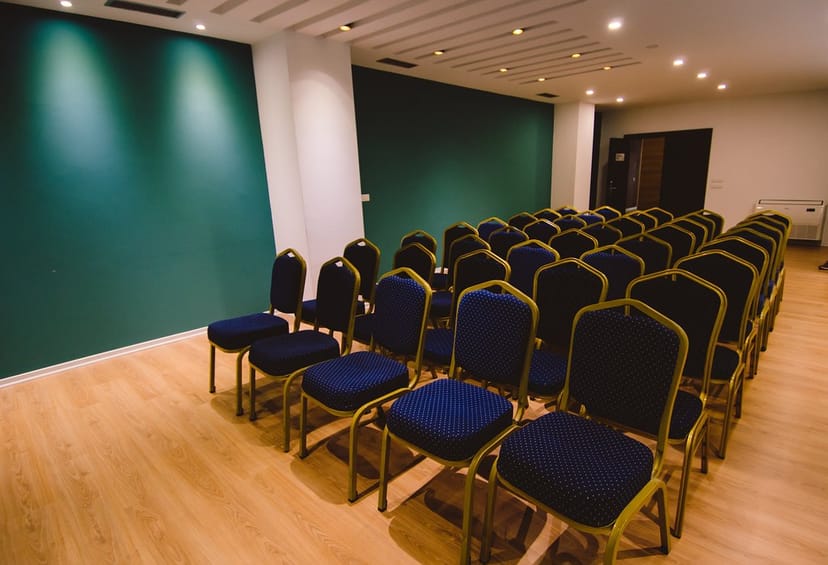 Modern meeting space with blue chairs at VH Premier as Tirana Hotel for events.