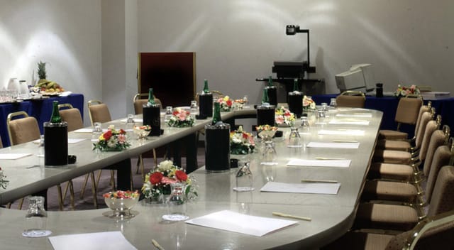 Elegant meeting room setup with floral centerpieces for professional conference.