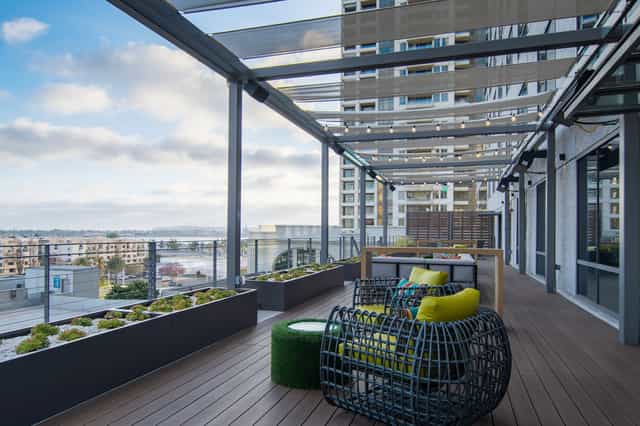 Modern rooftop event space with stylish seating and greenery for networking gatherings.