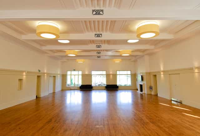 Spacious function room with polished floors for conferences and social gatherings.