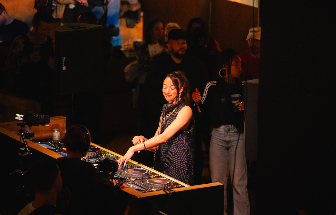DJ energizing a diverse crowd at Christmas event in No90 Hackney Wick. - Banner
