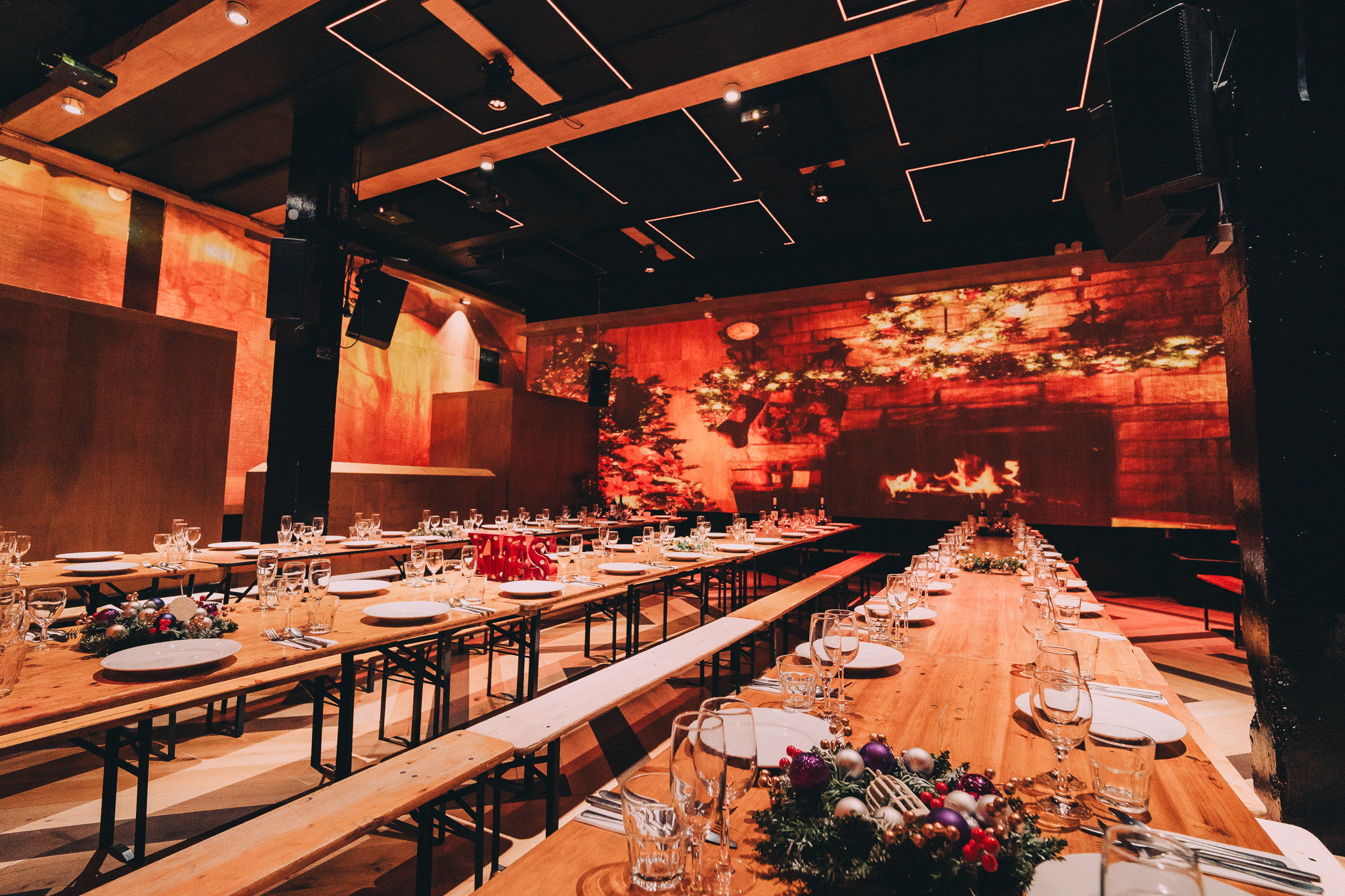 Christmas event space at No90 Hackney Wick with elegant table settings and warm lighting. - Banner