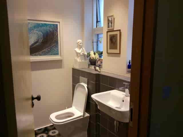 Sophisticated restroom with art decor at HOURS for luxury corporate events and venue hire.