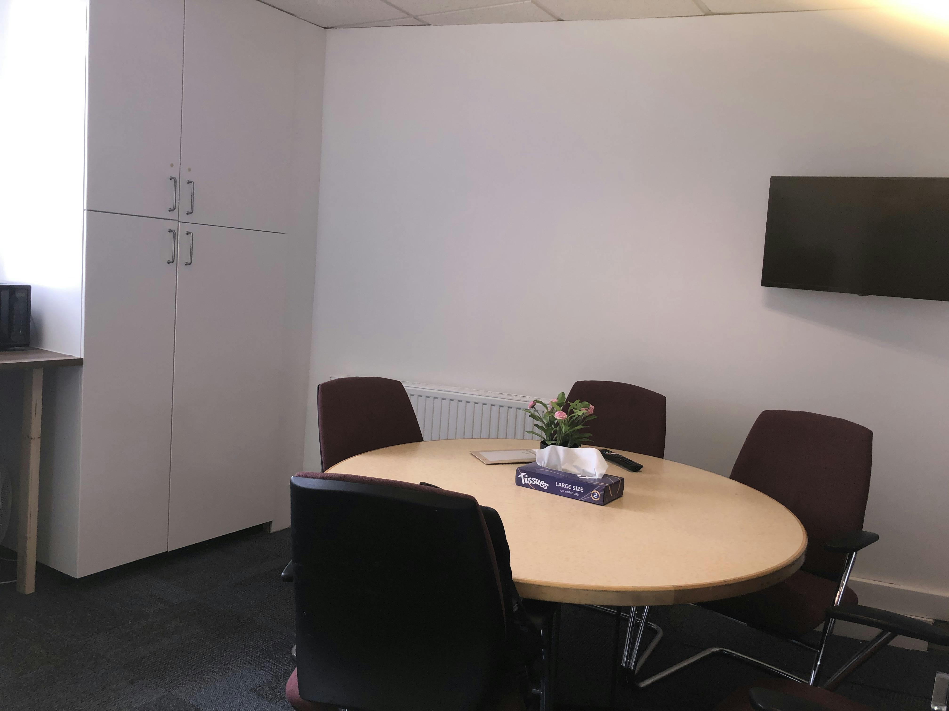 Board Room at School of Leadership with round table, ideal for meetings and presentations.