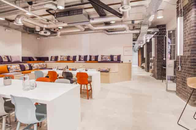 Industrial-chic breakout space with tiered seating for collaborative workshops and networking events.