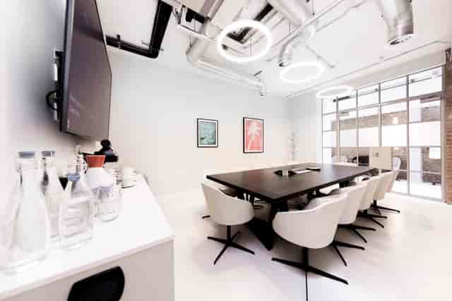 Industrial-chic boardroom with integrated tech for professional meetings and corporate events.
