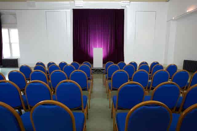 Indus Hall at Kala Sangam Arts Centre, elegant podium for formal conference event.