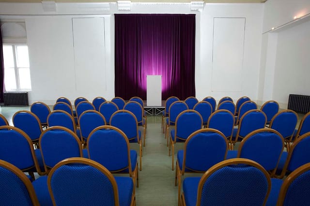 Indus Hall at Kala Sangam Arts Centre, elegant podium for formal conference event.