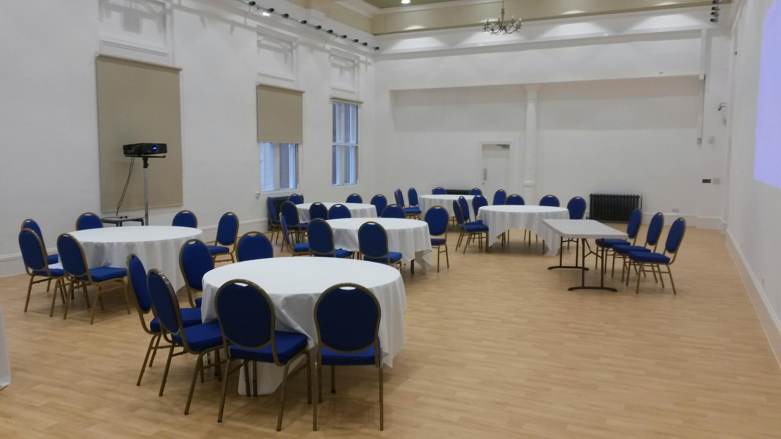 Indus Hall at Kala Sangam: versatile event space with round tables for networking sessions.