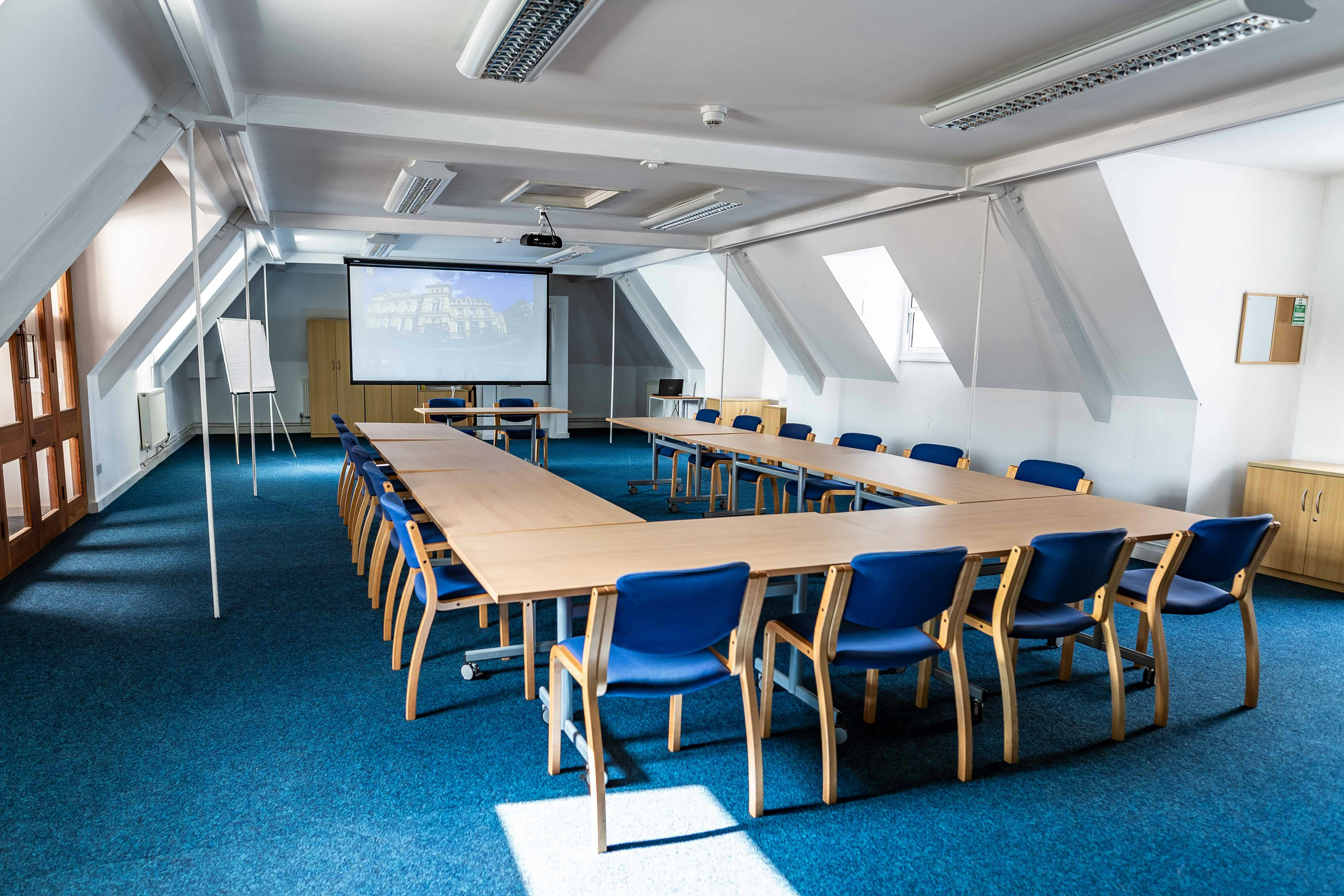 Clock Tower Suite meeting room with long table, ideal for workshops and presentations.