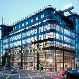 Modern glass building in Milan, perfect for corporate events and meetings. - Banner