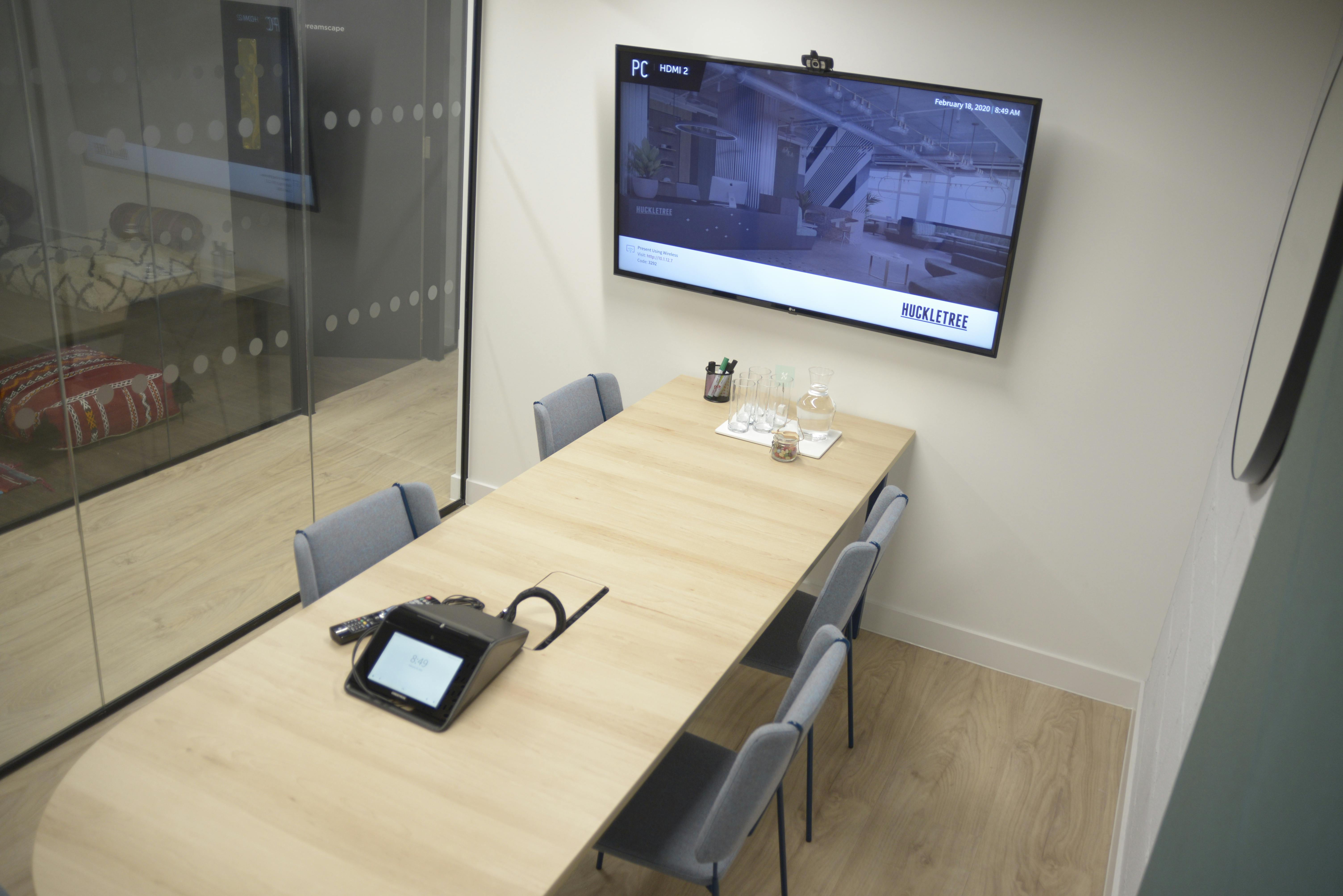 Modern Mars Meeting Room at Huckletree Soho with sleek wooden table for collaborative sessions.