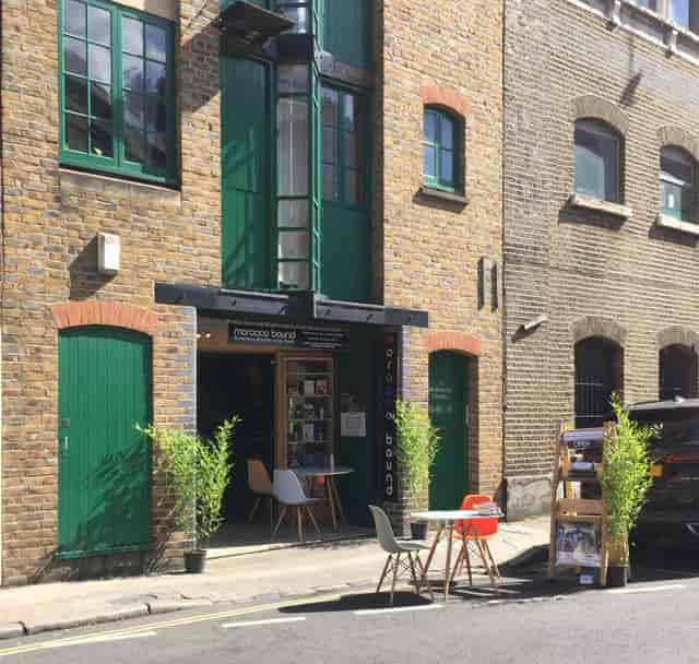 Whole Space in Morocco Bound Bookshop with rustic brick and green doors, perfect for events.