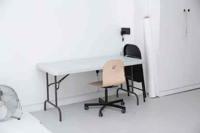 Minimalist Cove Studio setup with folding table and chairs for events and meetings.