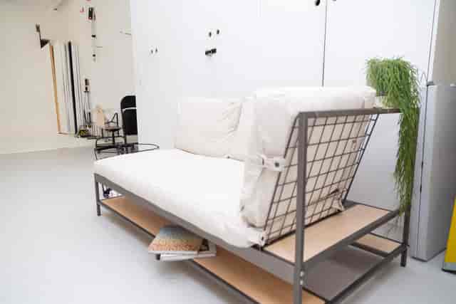 Minimalist lounge at Cove Studio with industrial sofa for networking events.