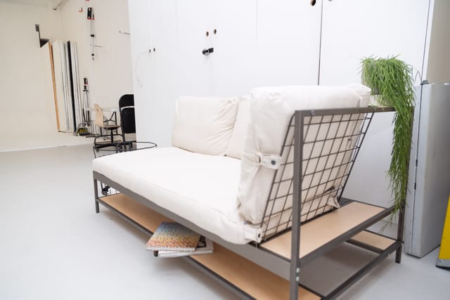 Minimalist lounge at Cove Studio with industrial sofa for networking events.
