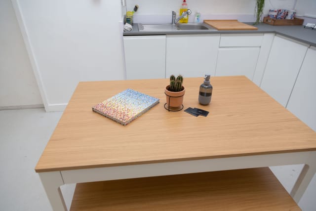 Minimalist workspace at Cove Studio, featuring a light wood table for meetings and events.