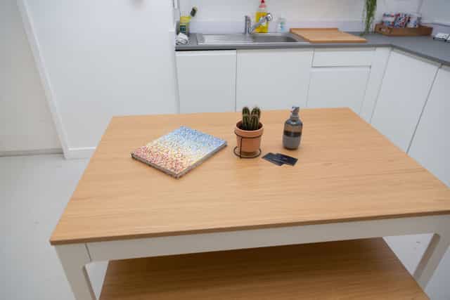 Minimalist workspace at Cove Studio with light wood table for brainstorming sessions.
