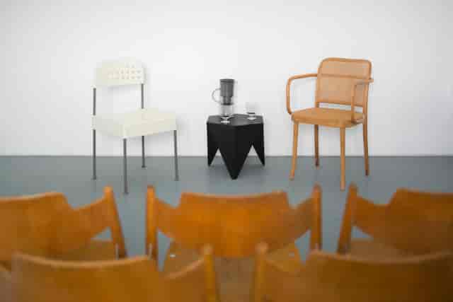 Minimalist panel discussion setup with chairs and water pitcher on Spelman Street.