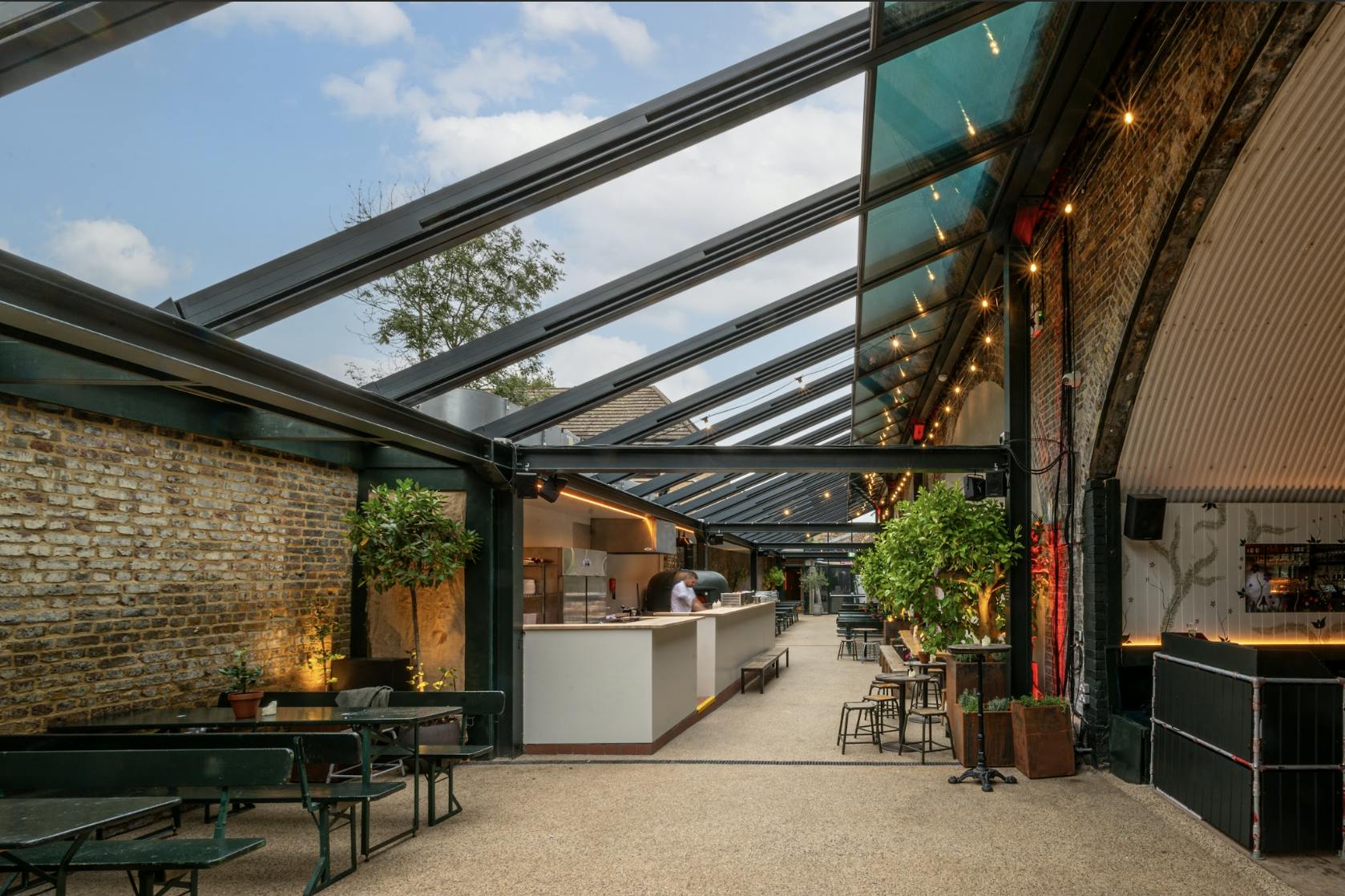 Versatile event space with glass roof, ideal for gatherings and workshops at The Hawk's Nest.