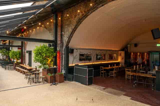Terrace at The Hawk's Nest: industrial-chic event space with exposed brick and greenery.