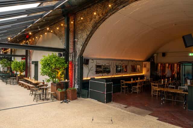 Terrace at The Hawk's Nest: industrial-chic event space with exposed brick and greenery.