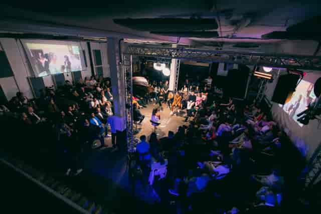Dynamic event space at 90 Live in Studio 9294 with engaged audience and screens.