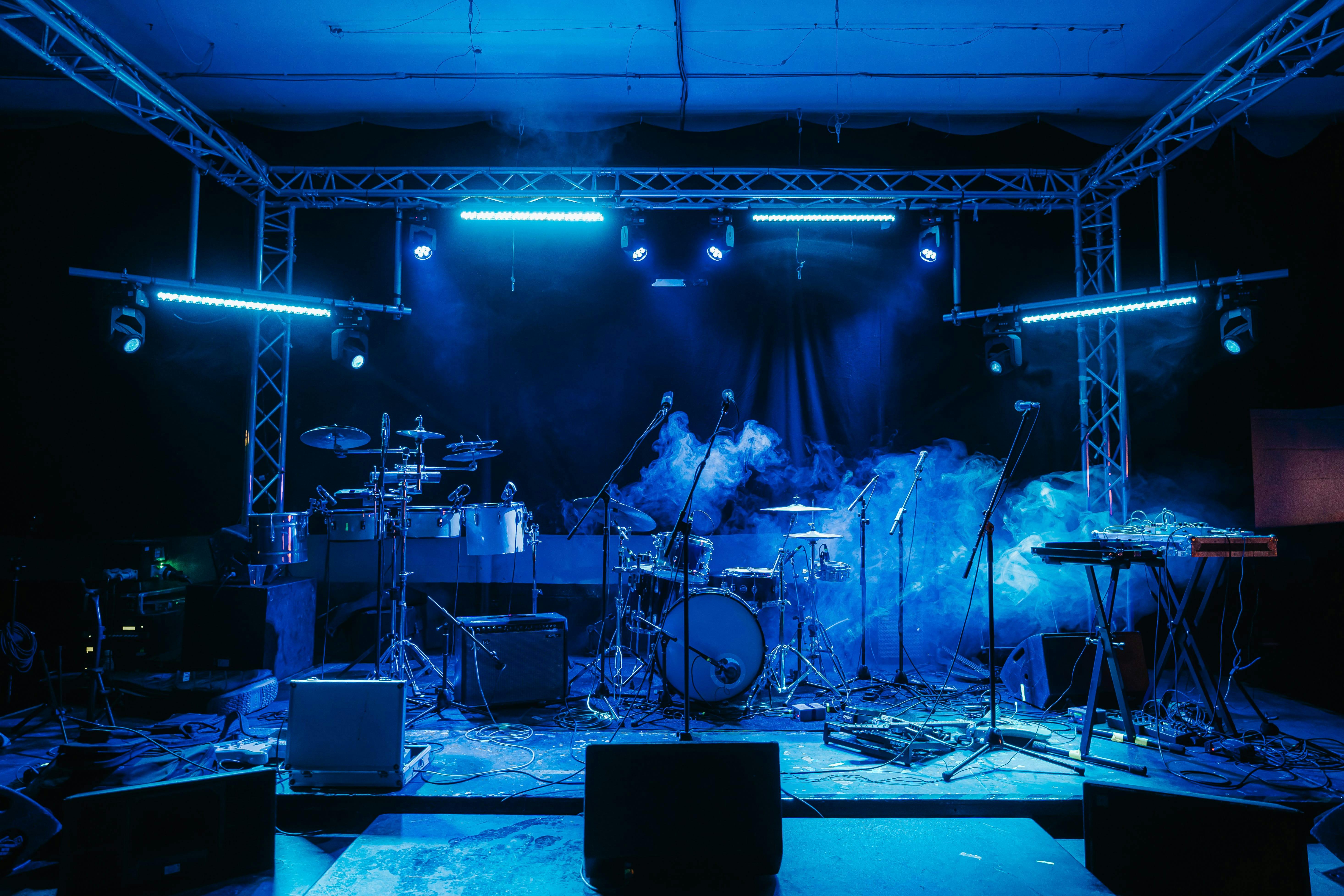 Dynamic stage setup with blue lighting for live concerts and corporate events.