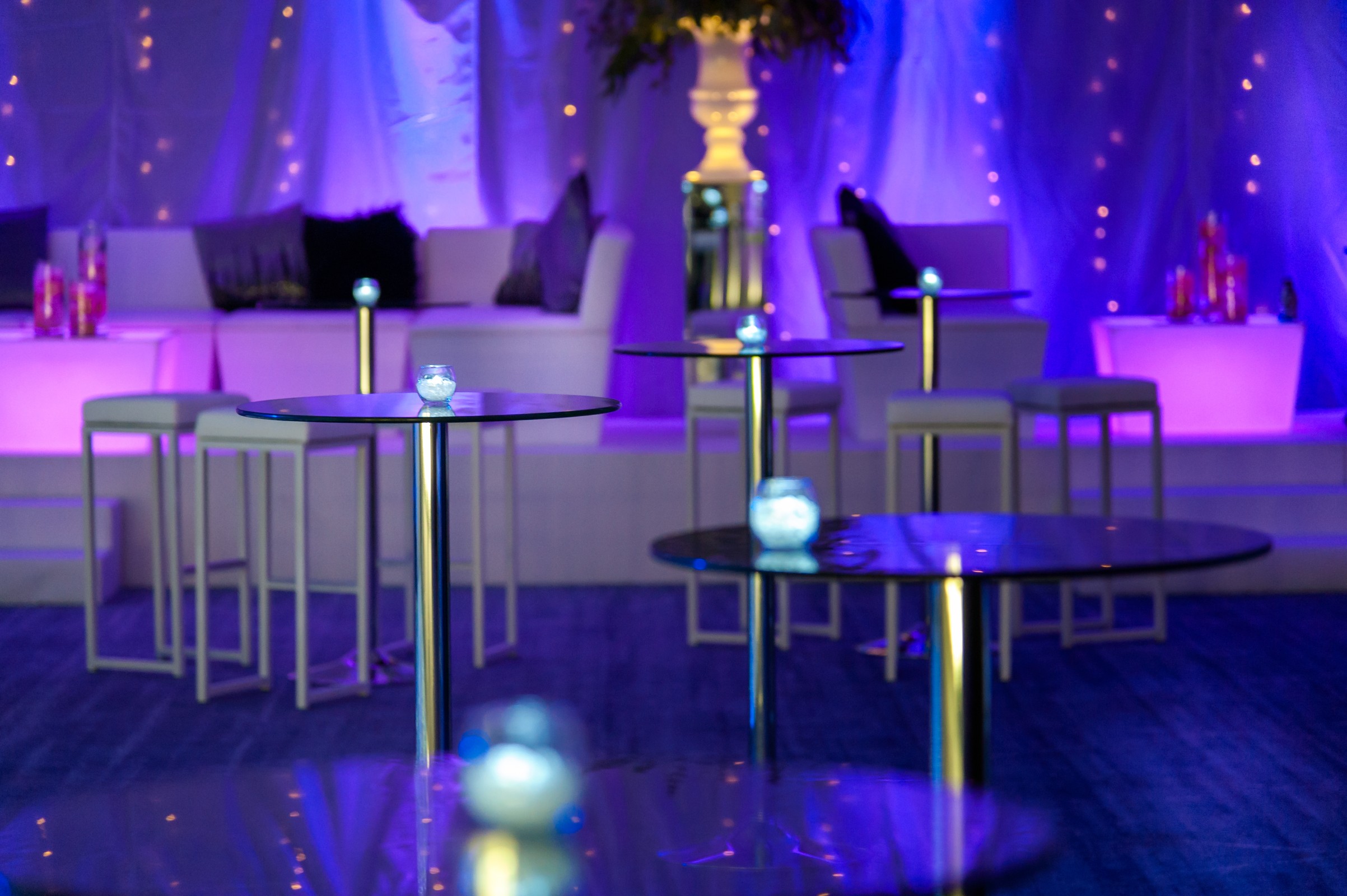 Stylish event space in Tower AB, Hilton London, with modern furniture and purple lighting. - Banner