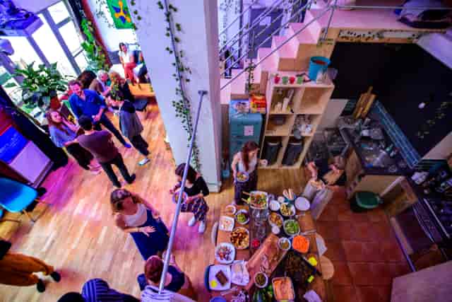 Vibrant networking event at House of Transformation with buffet and greenery.