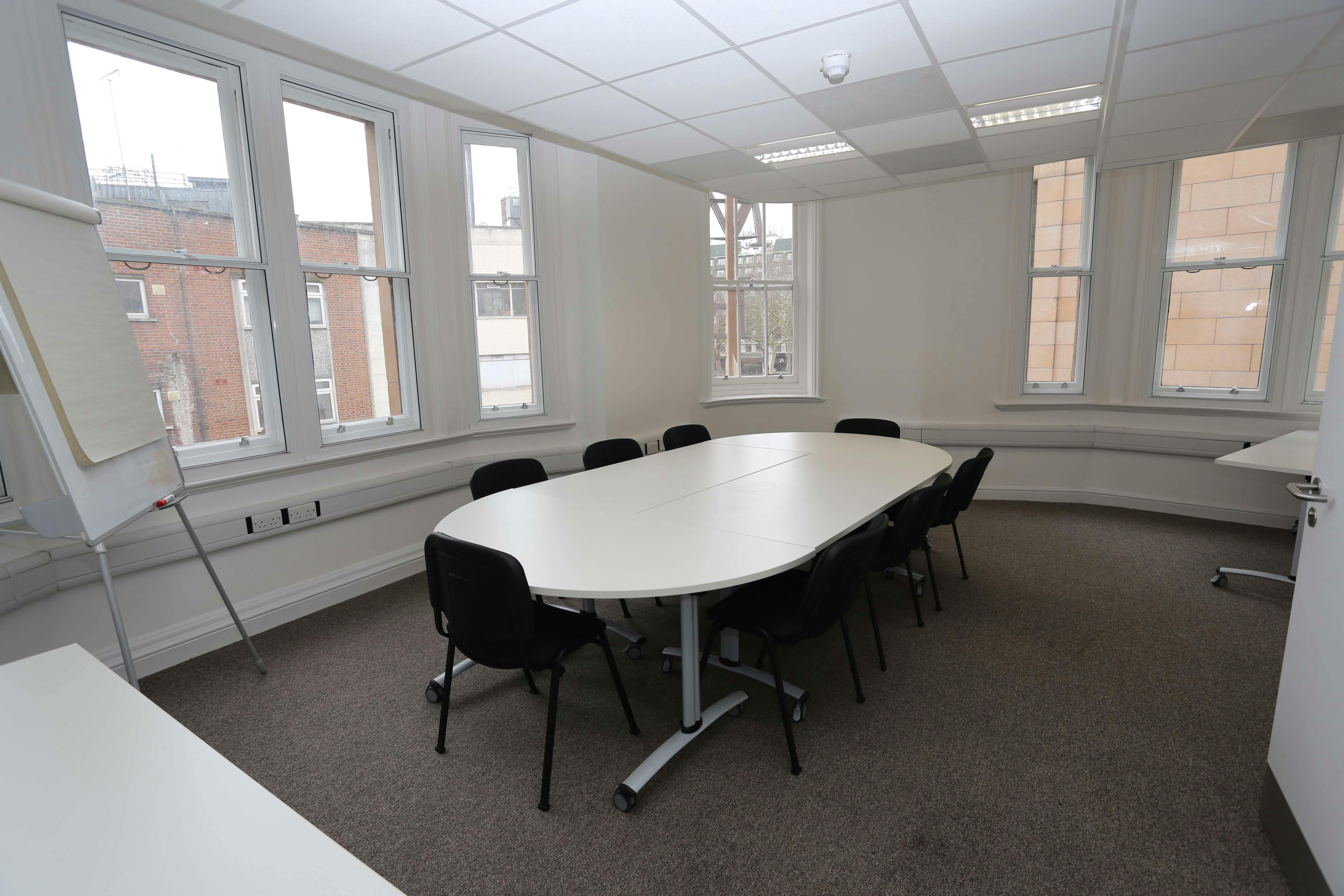 Main hall in Chinese Community Centre, oval table, ideal for meetings and presentations.