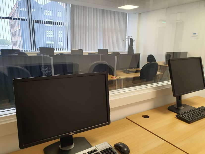 Modern conference room with computers, ideal for workshops and training sessions.