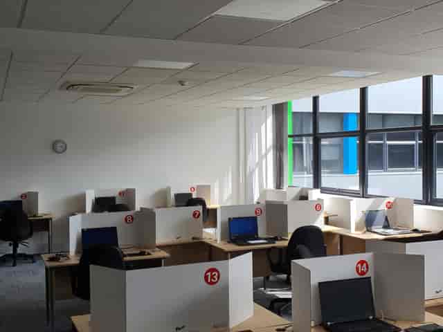 Modern exam training room with computers, ideal for workshops and team events.