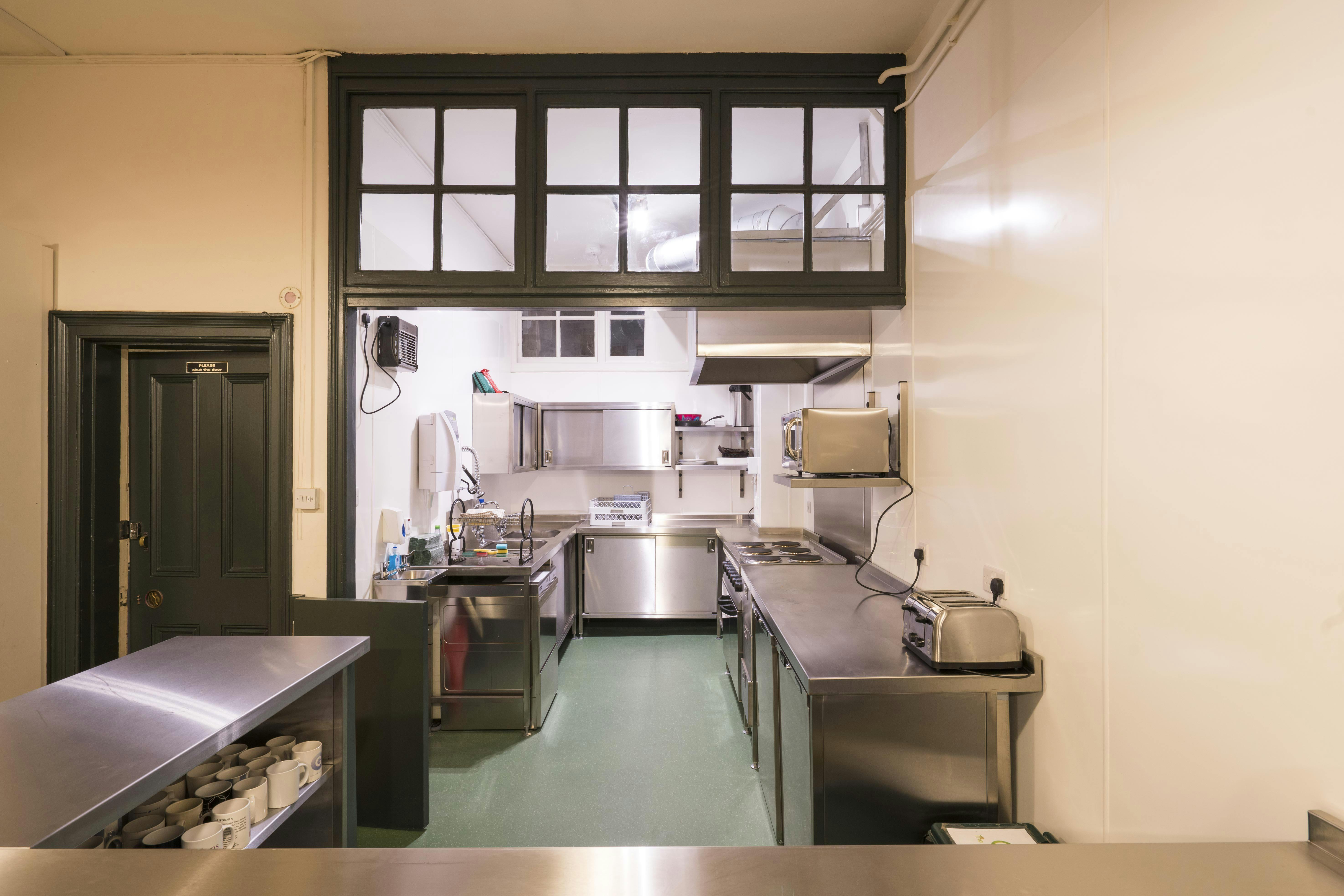 Commercial kitchen in Unity Islington, stainless steel surfaces, catering events setup.