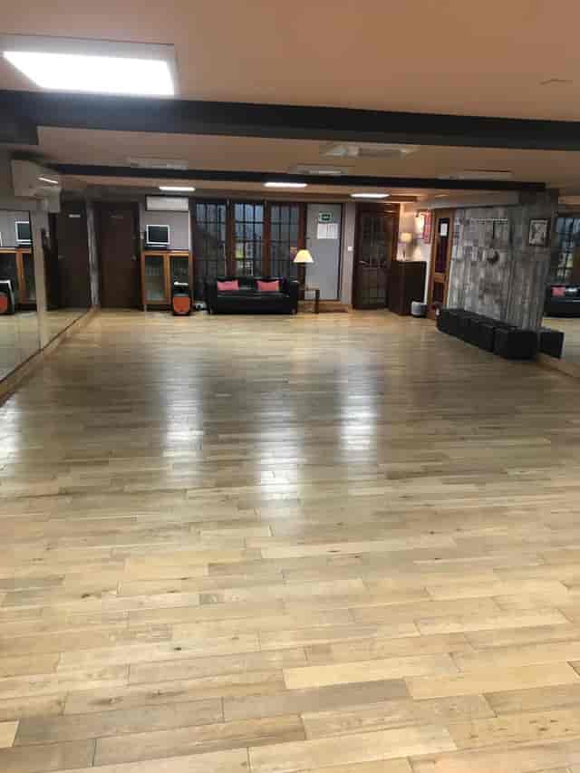 Spacious event venue with polished floors, ideal for meetings and workshops.