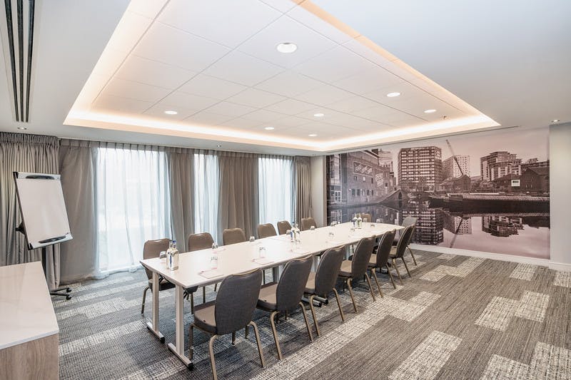 Modern Meeting Room Nine with long table, ideal for workshops and strategic meetings.