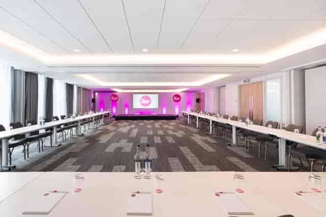 Modern Ashtead Suite meeting room with U-shaped tables, ideal for corporate events.