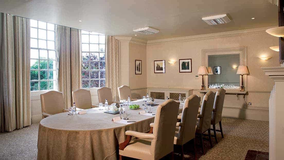 Boardroom at Brandshatch Place Hotel, round table setup for meetings and events.