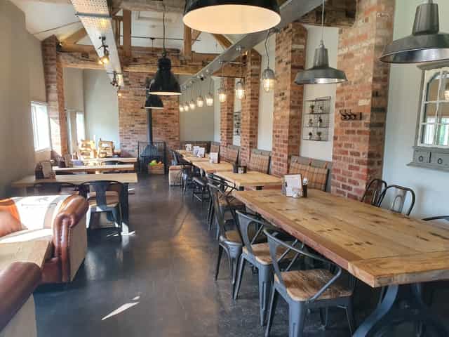 Spacious rustic venue with exposed brick for meetings and events at Espresso Farm.