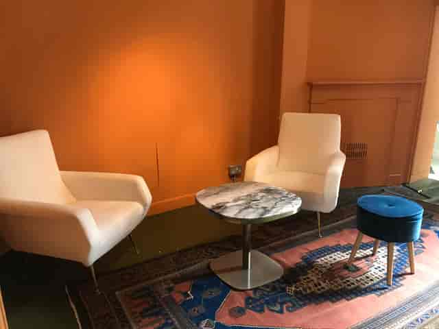 Cozy meeting space in Café Babka with modern armchairs, ideal for brainstorming events.