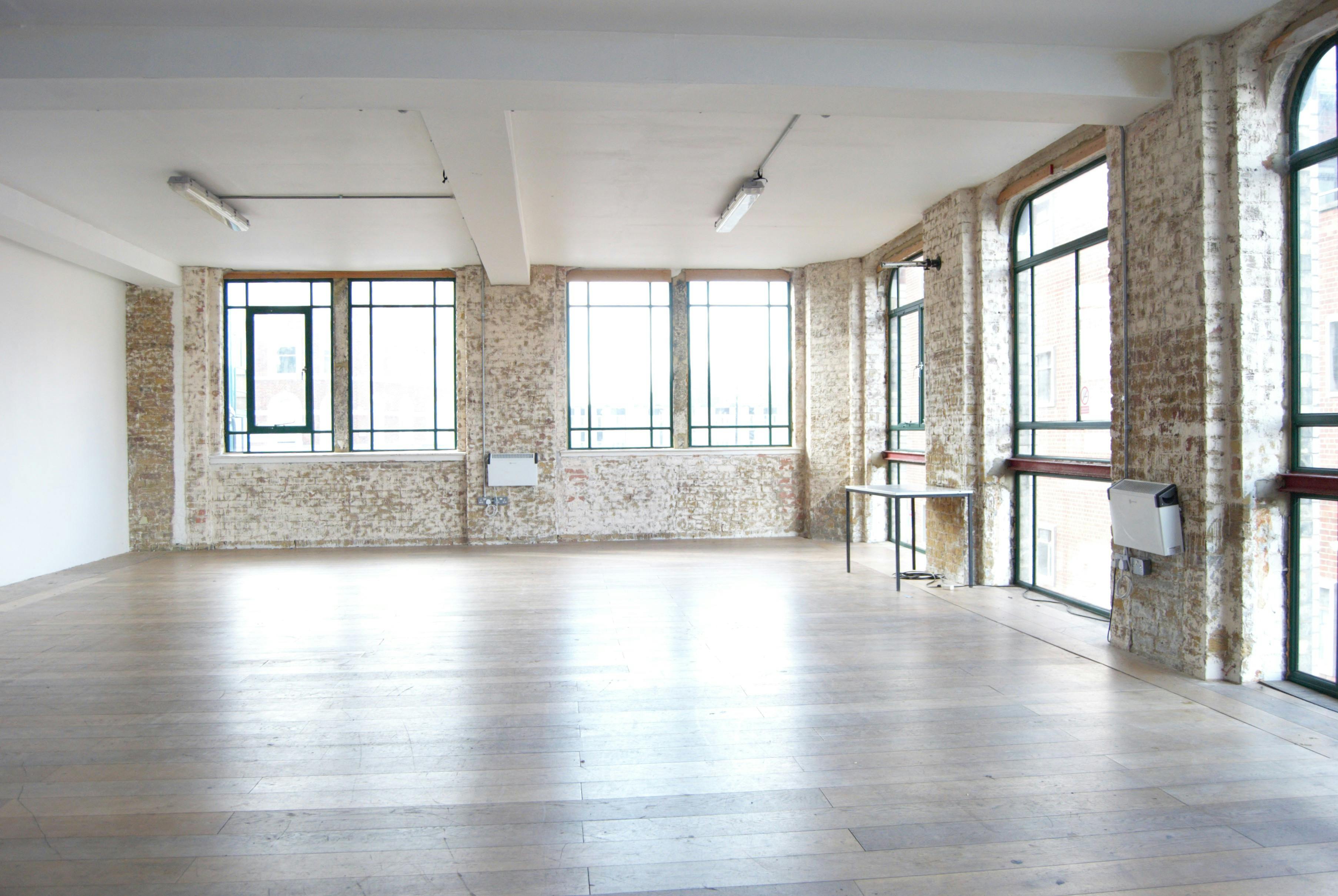 Spacious Studio 4 at Arcola Theatre, featuring large windows for workshops and meetings.