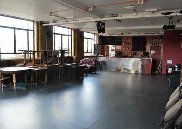 Versatile event space with large windows at Arcola Theatre & Bar for gatherings and meetings.