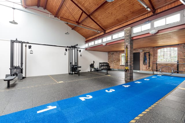 Versatile fitness venue with workout stations for corporate wellness events and team-building.
