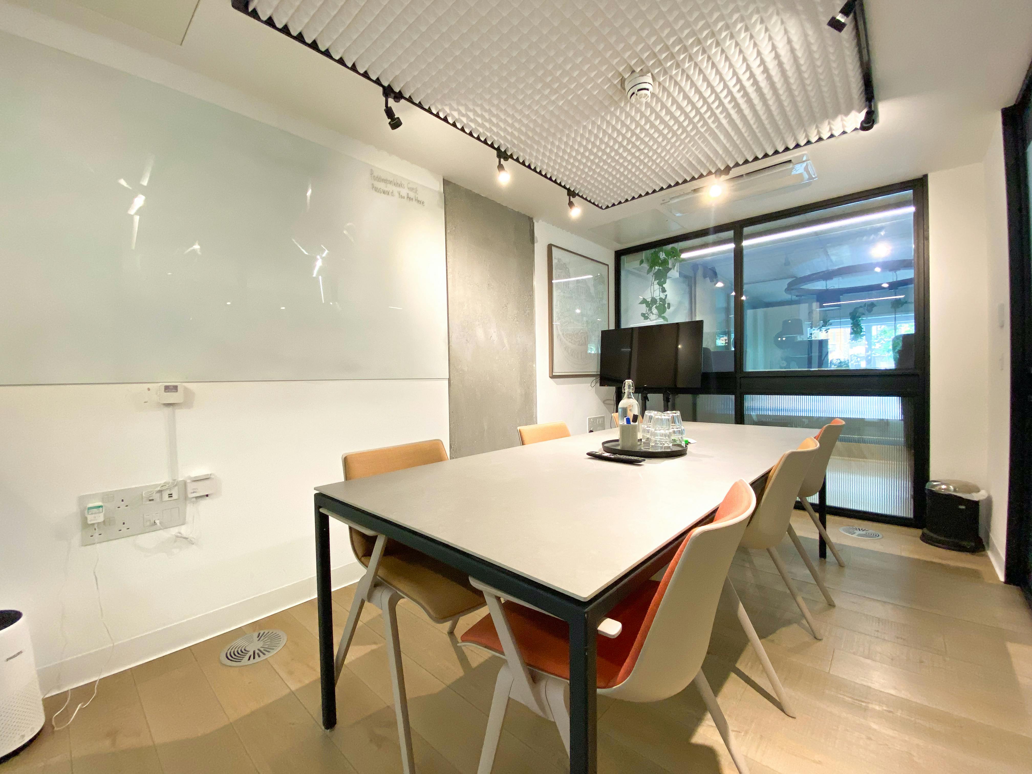 Modern meeting room with large windows at Storey Club Paddington Central for collaboration.