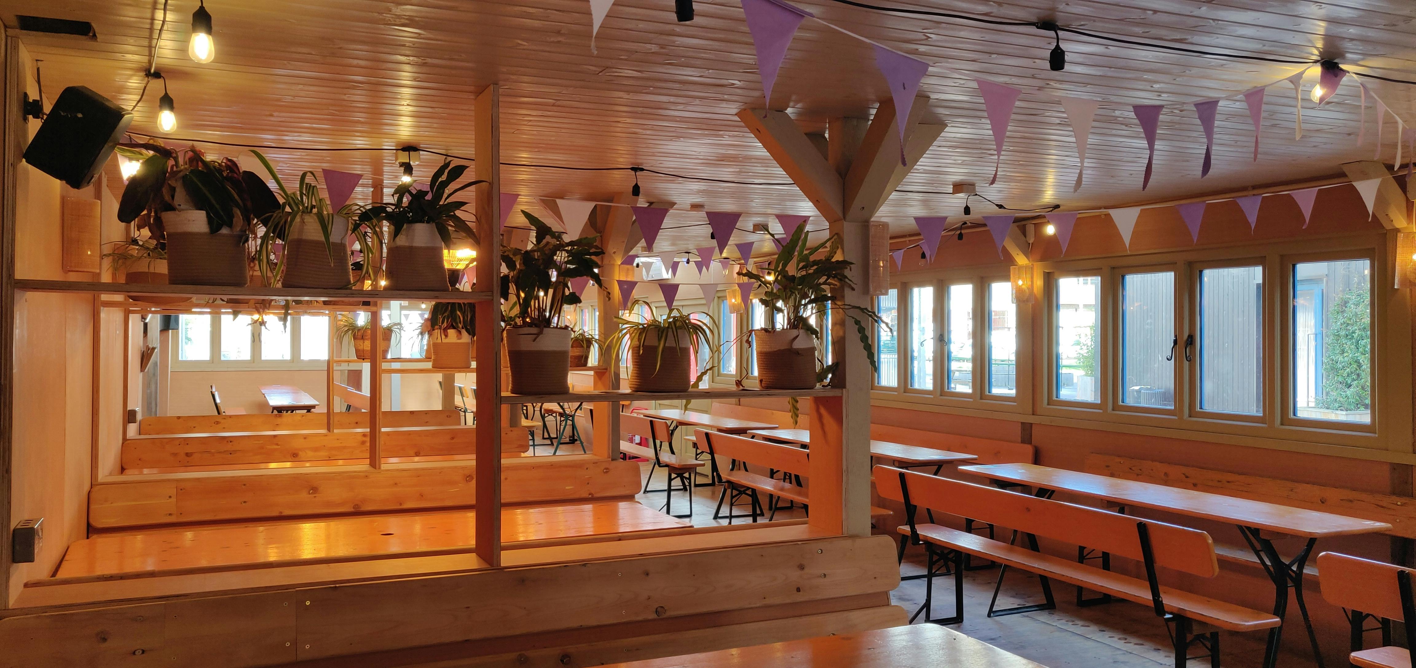 Log Cabin event space in Hackney Bridge with cozy wooden decor and natural light.