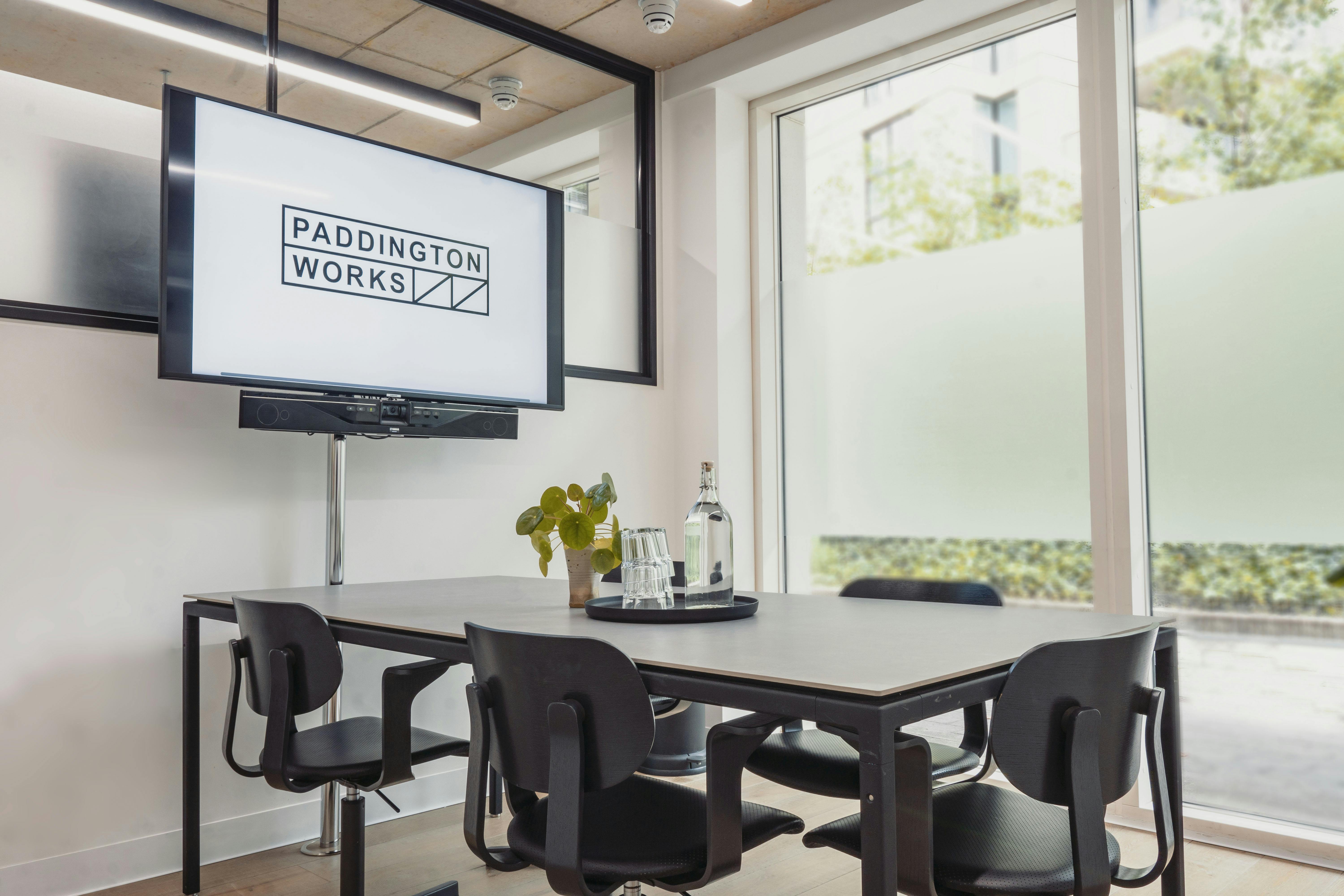 Modern meeting room with sleek table, ideal for presentations and collaboration.