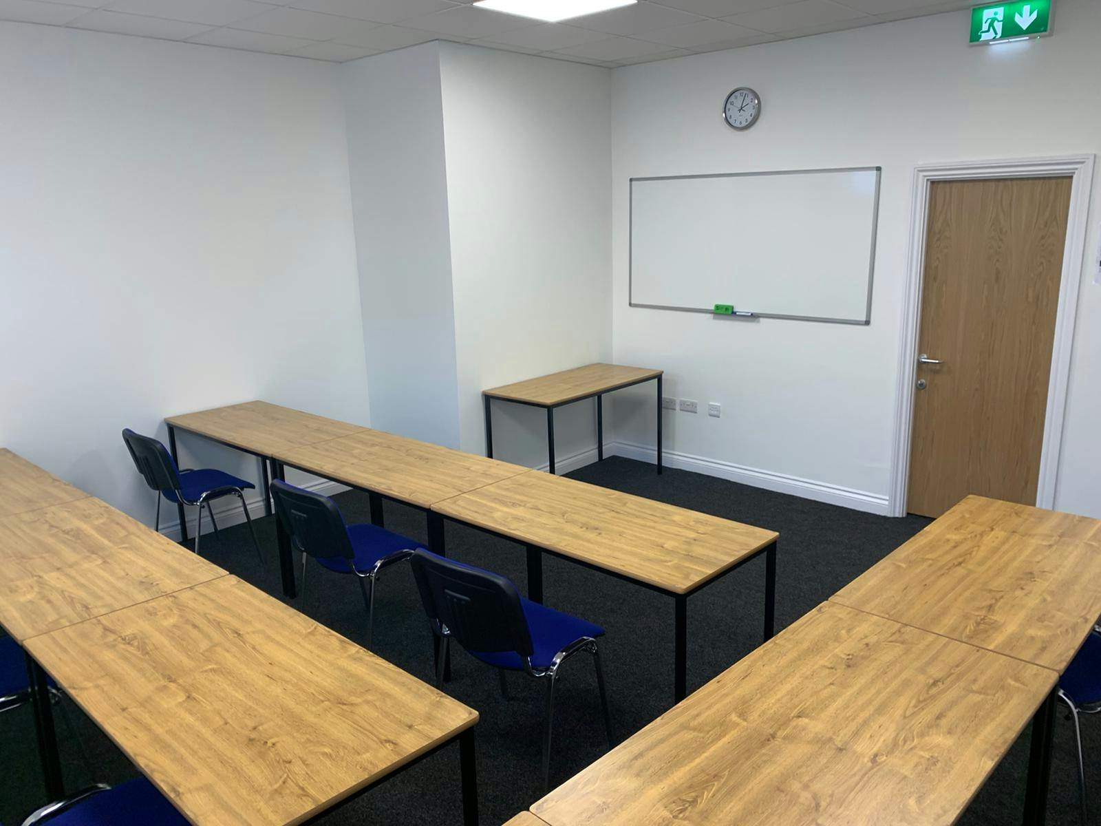 Meeting Room 3 at Bridge School: U-shaped tables for training sessions and workshops.