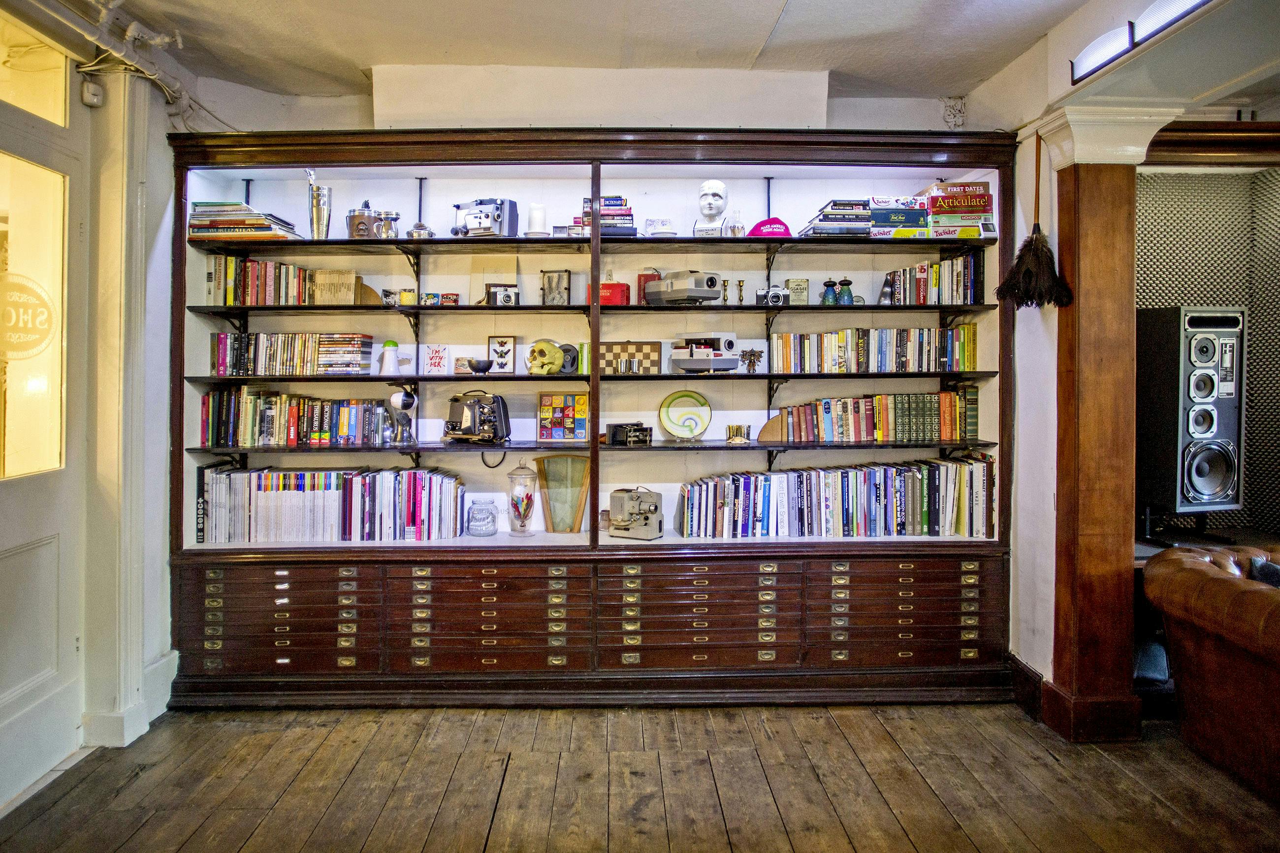 "Inviting bookshelf backdrop for meetings and events in Anomalous Space."