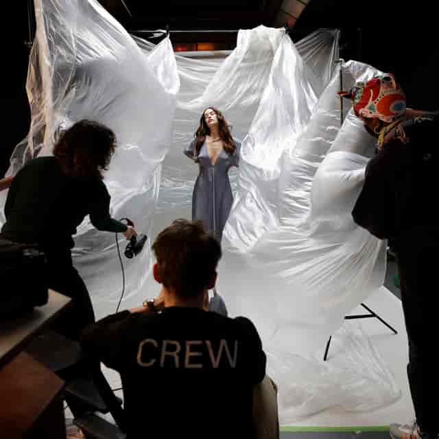 Dynamic event photoshoot with flowing materials showcasing teamwork and creativity.