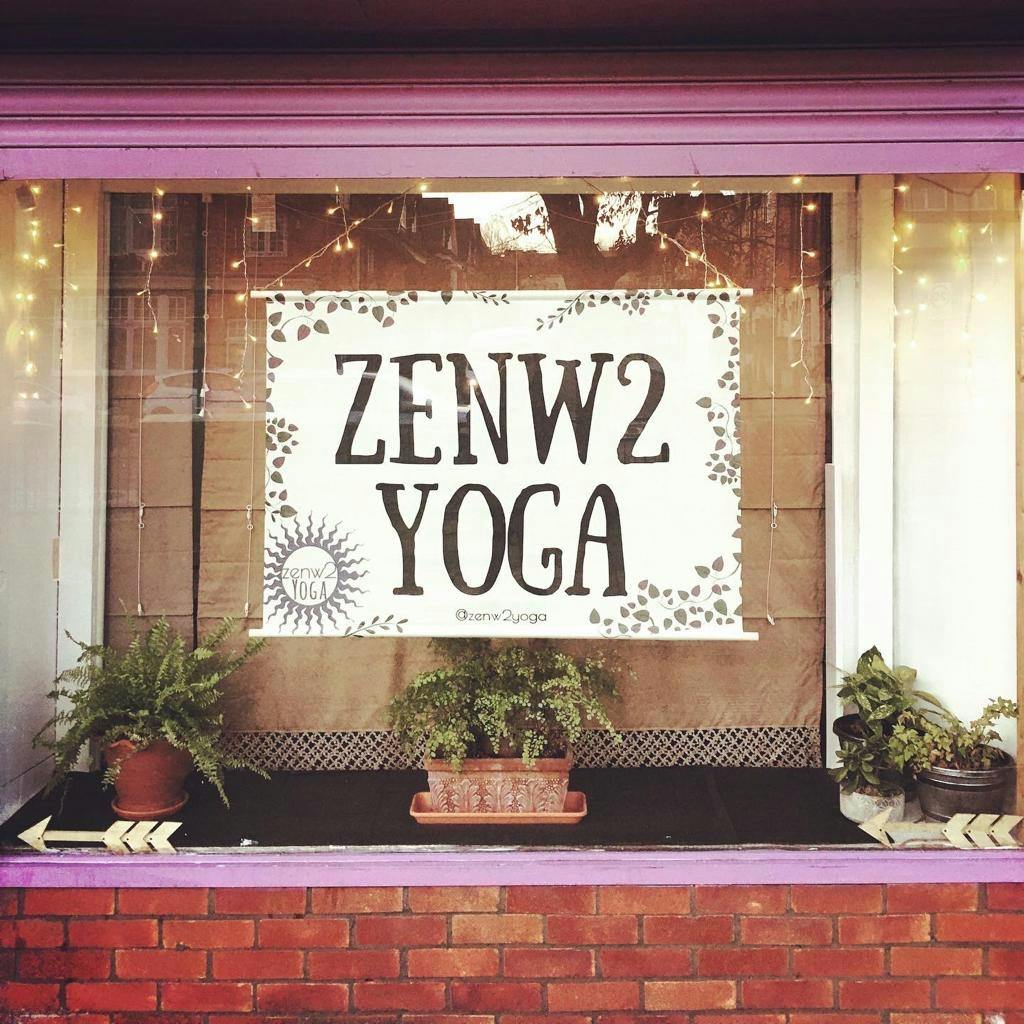 Welcoming Zenw2 Yoga studio storefront with warm lighting, ideal for wellness retreats.